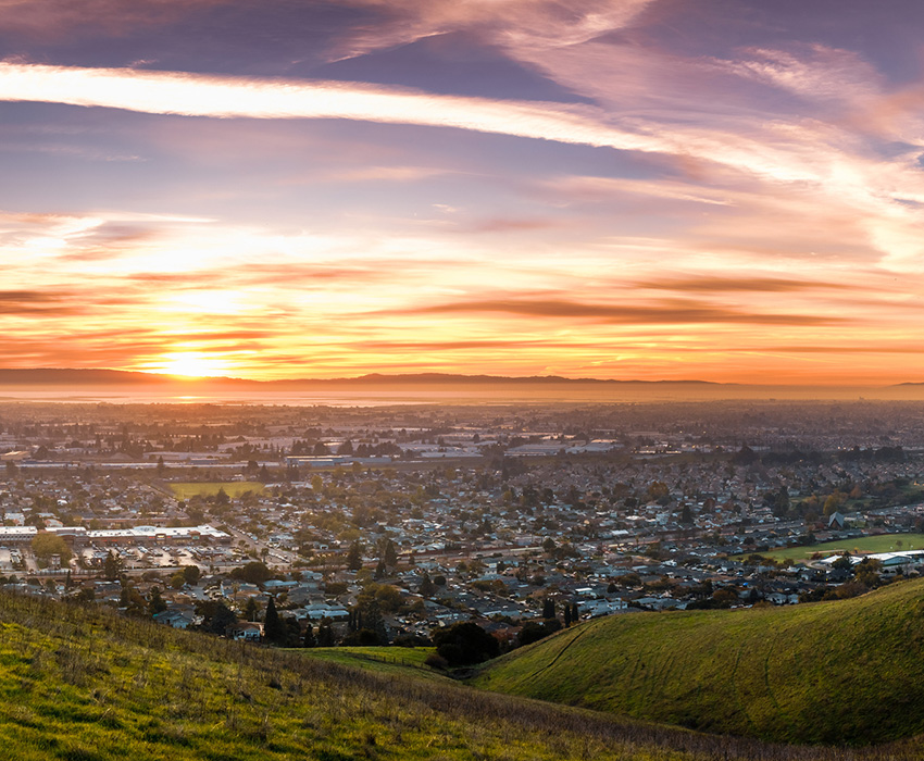 los altos cityscape at sunset with green hills in the foreground