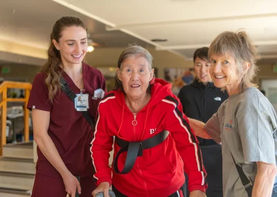 a resident with two rehab therapists in the rehab gym at Los Altos Sub-acute