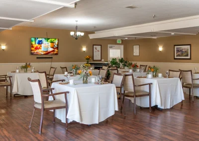 several tables set with linen and decoration and place settings at Los Altos Sub-acute